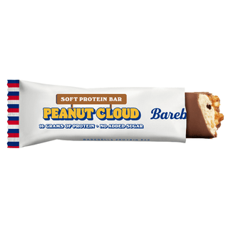 Barebells Soft Peanut Cloud delvis uppvecklad, mjuk vit nougat med jordnötsbitar synlig.